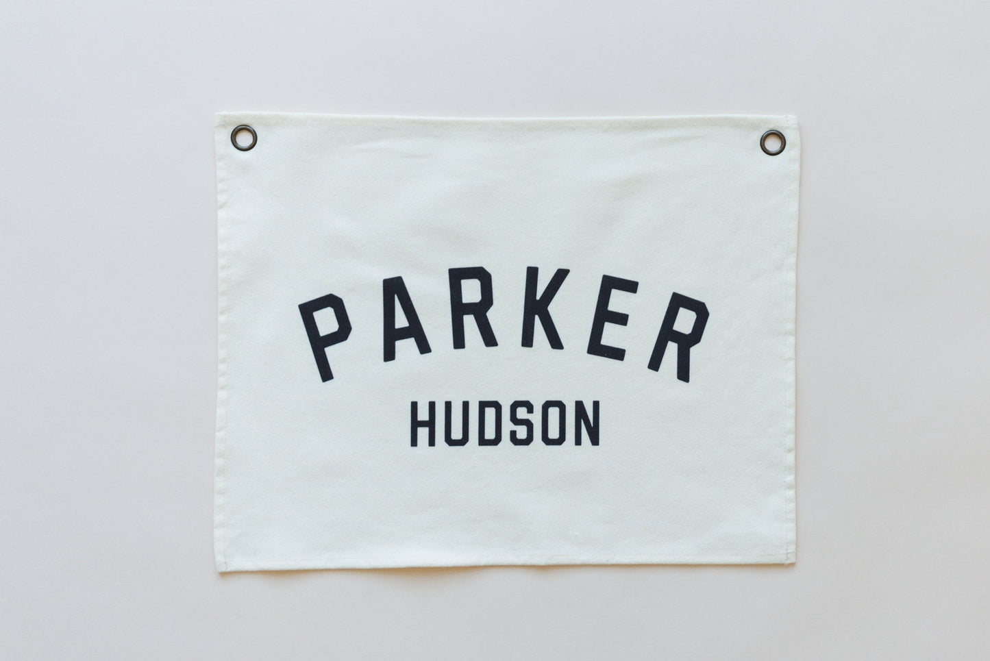 Custom canvas baby name banner in white with black letters Parker Hudson from Little Joy Co