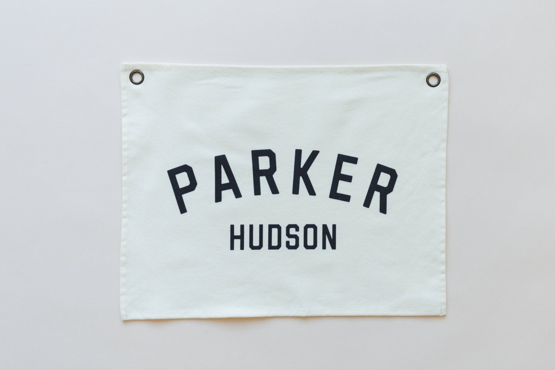 Custom canvas baby name banner in white with black letters Parker Hudson from Little Joy Co