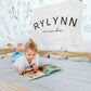 Custom canvas baby name banner with the name Rylynn Amanda hanging on wall in child's bedroom
